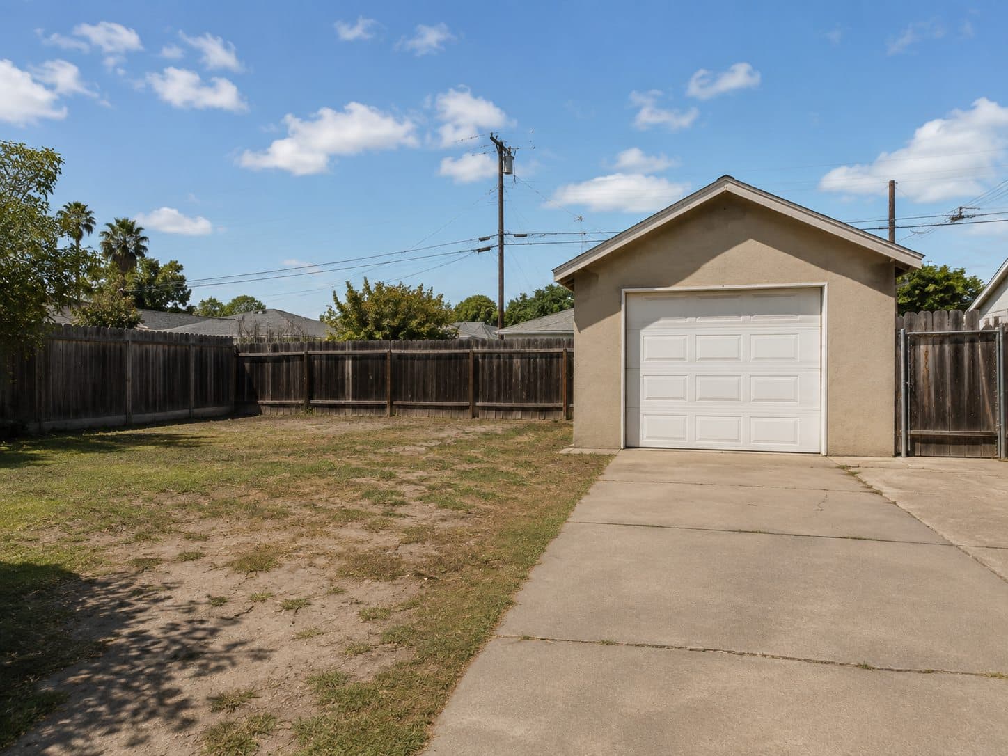 Existing detached garage and yard before conversion