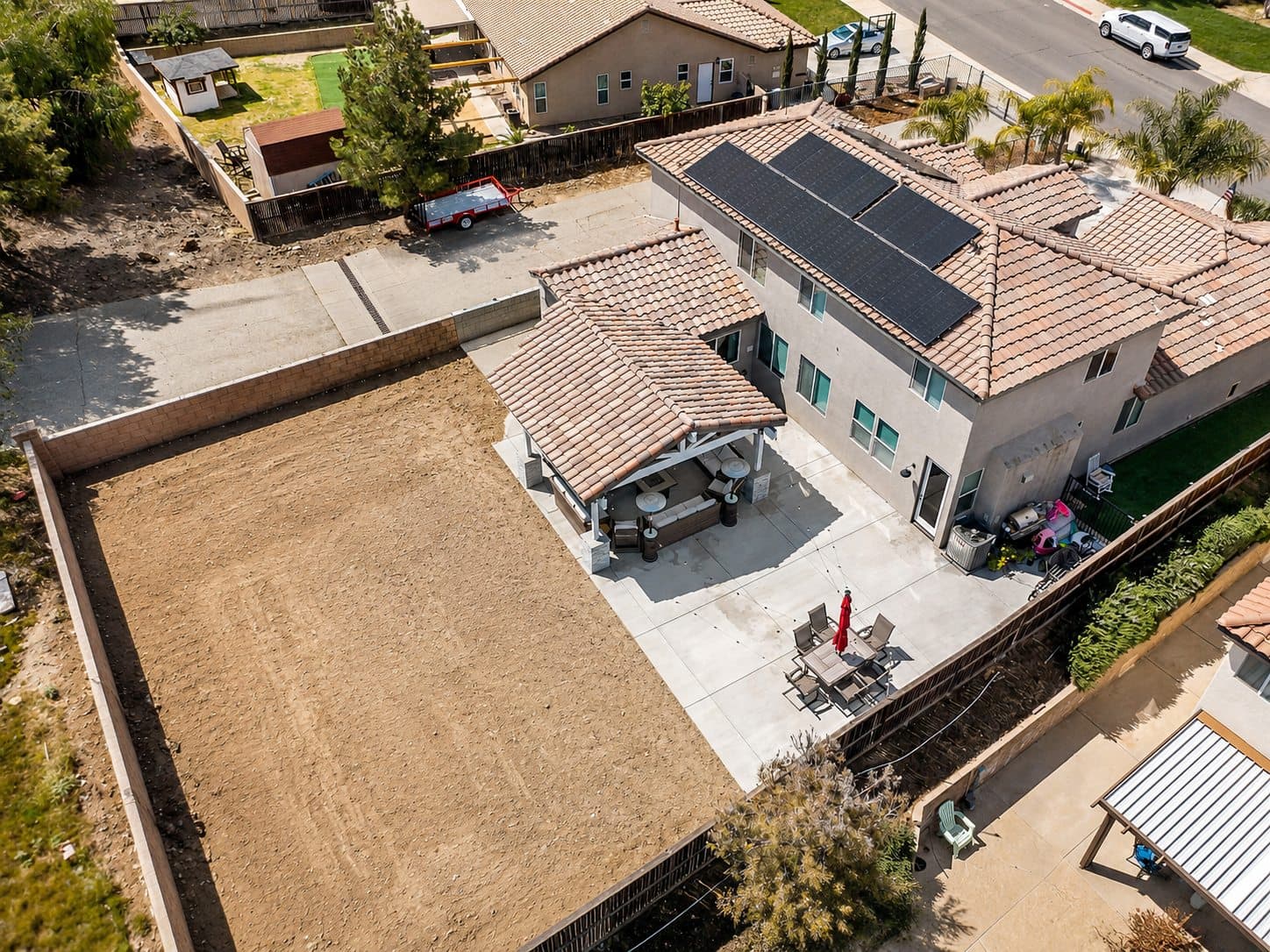 Aerial view of the graded backyard pad before construction